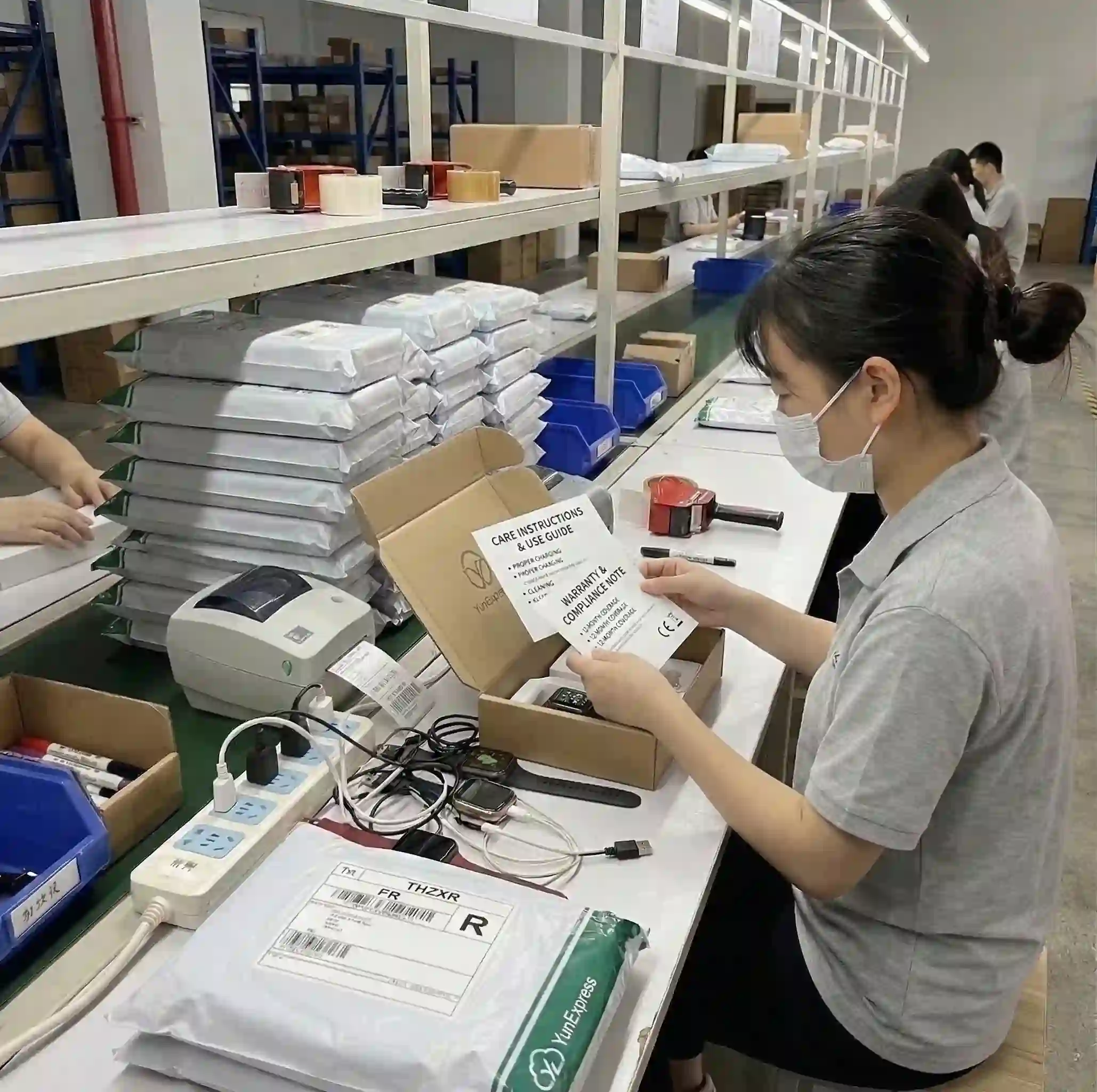 Fulfillment worker adding product inserts with care, warranty, and compliance information into a shipping box