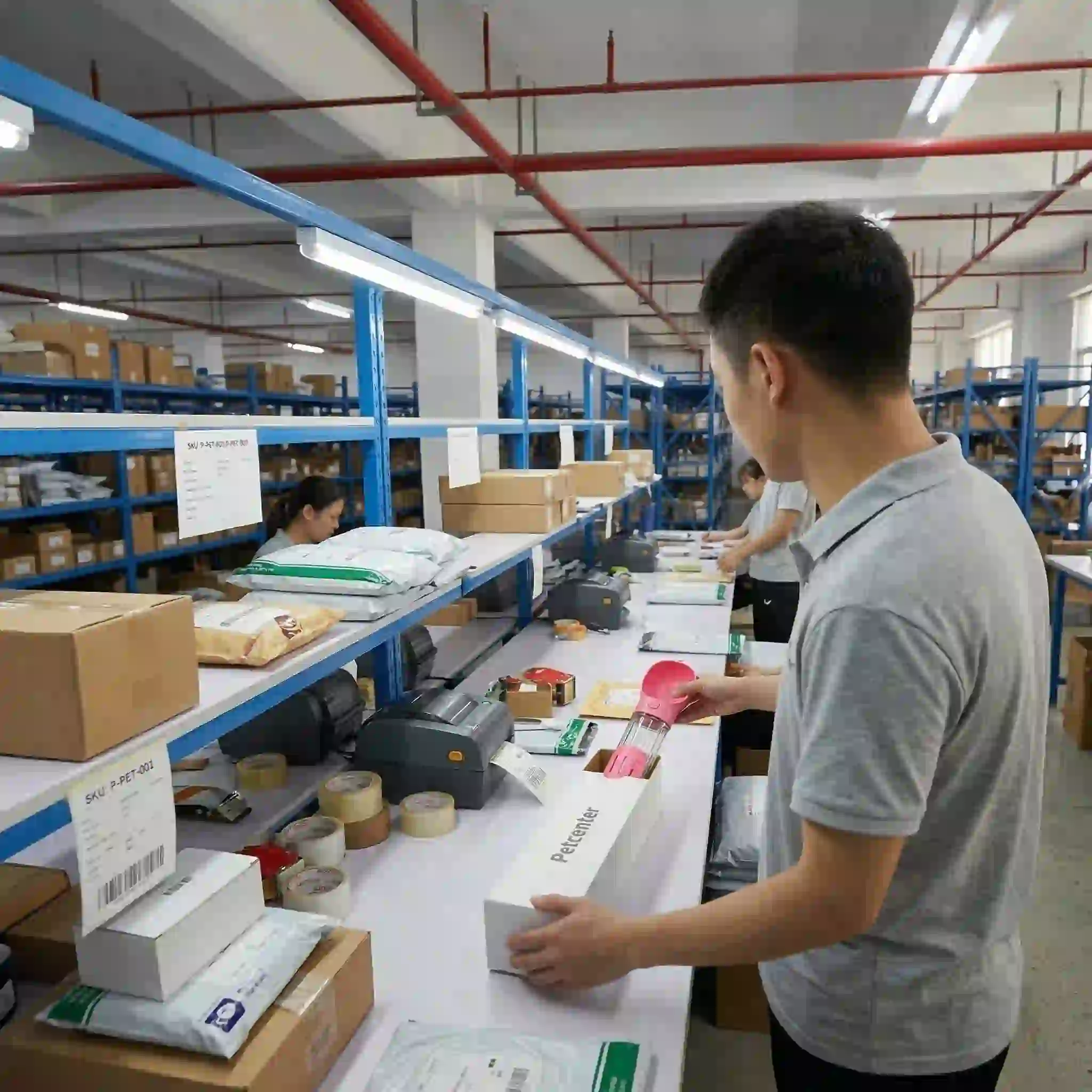 Warehouse staff packing pet product orders at a fulfillment station for high-volume ecommerce shipping
