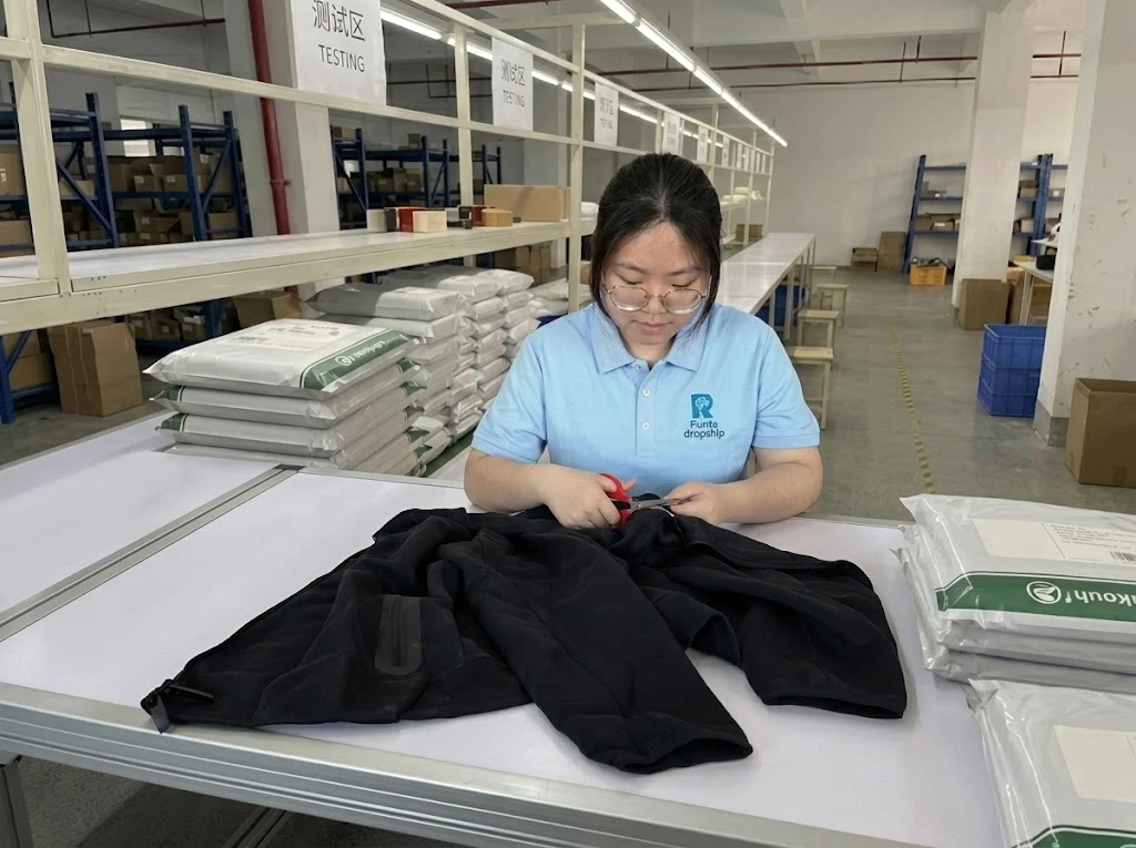 Staff trimming loose threads on a garment during apparel quality control in China