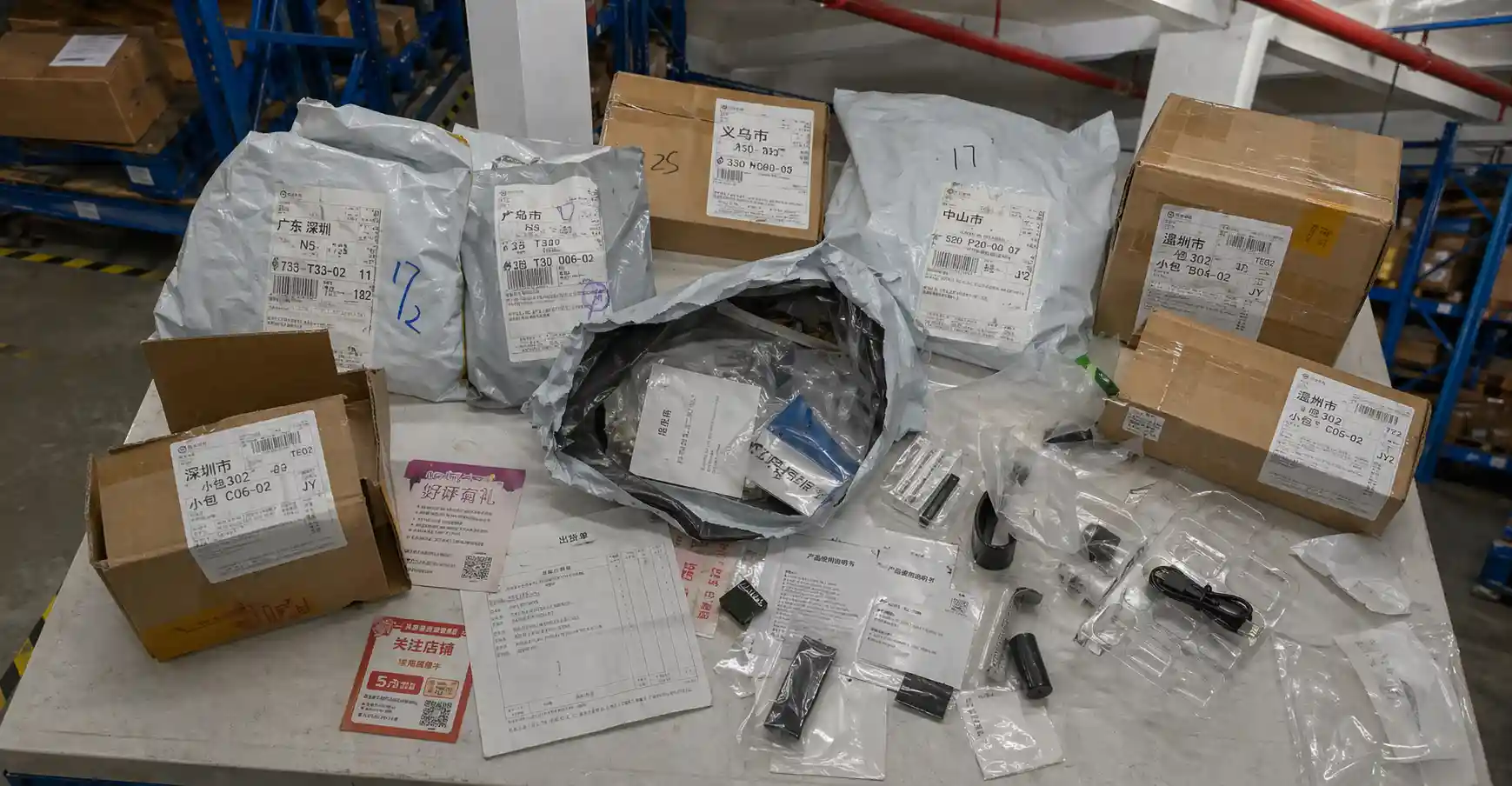 Messy supplier parcel with Chinese labels, invoices, inserts, and factory packaging before QC check